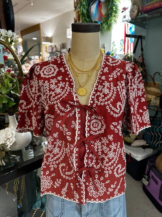 burnt orange top with white eyelet detail 
