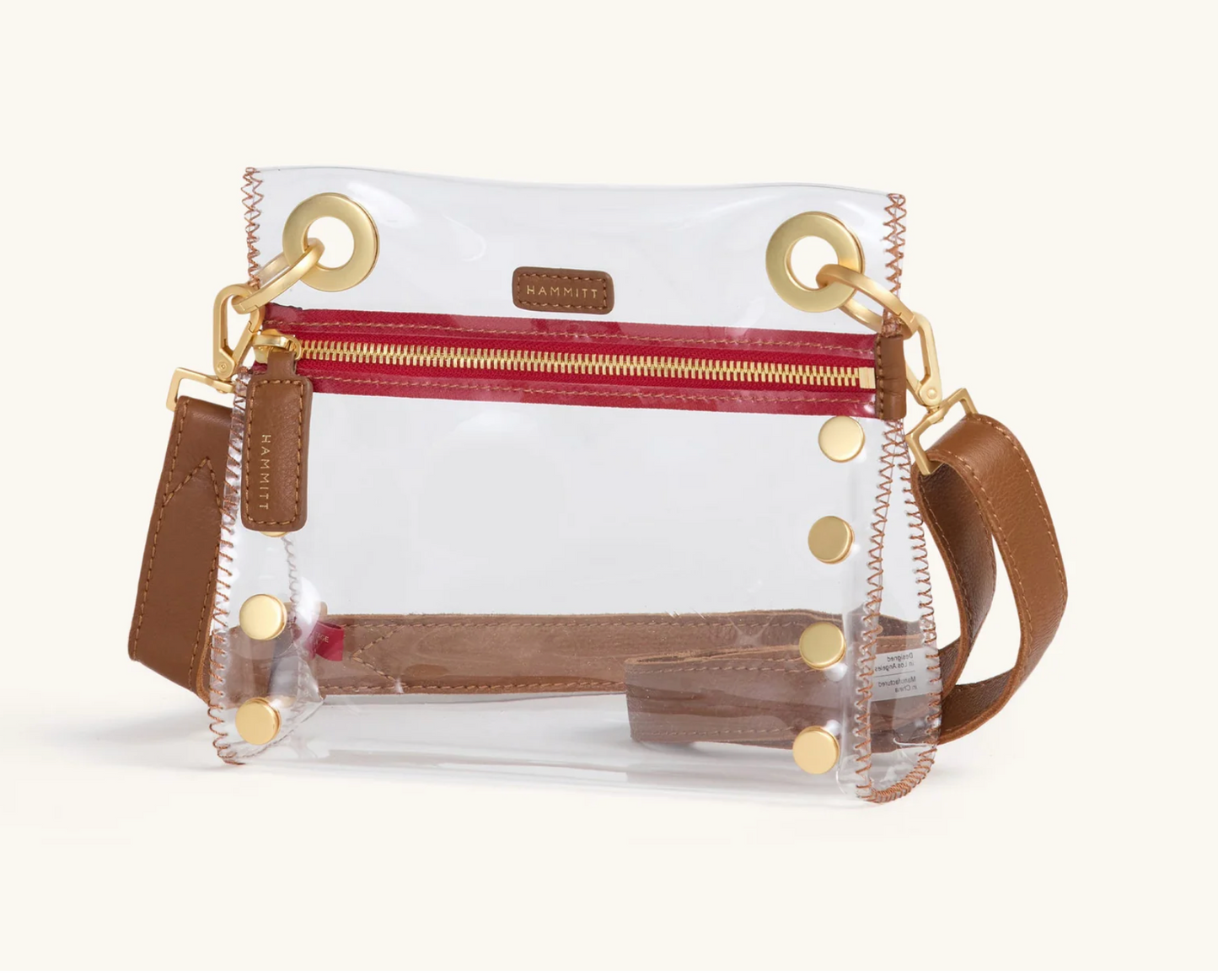 clear bag with red zipper and brown leather strap