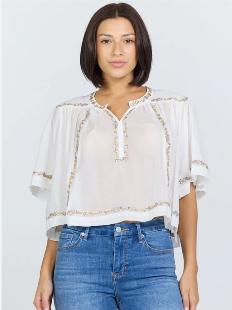 white short sleeve top with cream floral embroidery 
